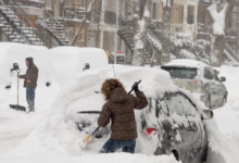 People shovelling out their cars after a snow storm in Montreal