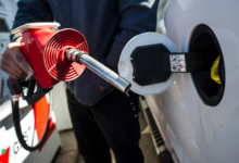 A man prepares to pump gas in Toronto